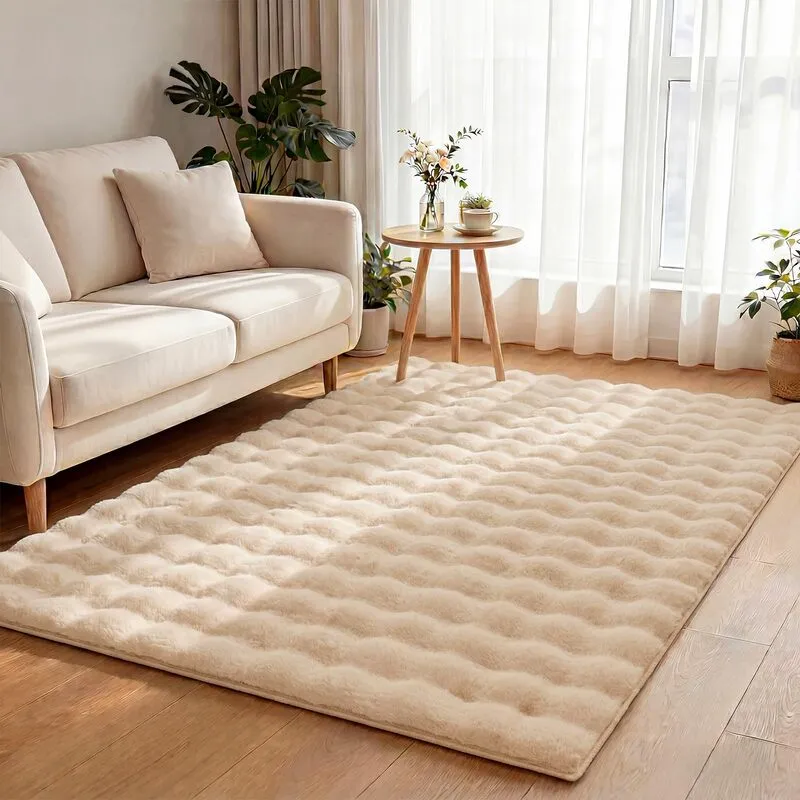 Cream textured plush area rug in front of a sofa